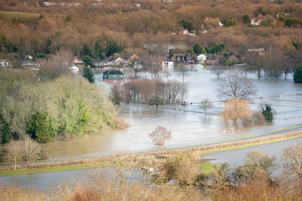 landscape of luxury homes and farmland under river floodwater